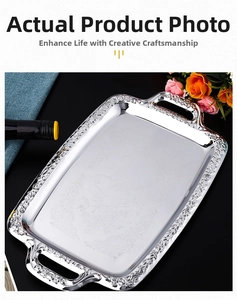 Macro detail of silver rectangular tray with peacock carving and vintage floral rim