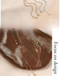 Detail of gold and silver Y-shaped zircon star pendant necklaces with stacking effect