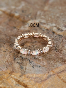 Macro shot of rose gold opal ring with small diamonds showing a 1.8cm inner diameter