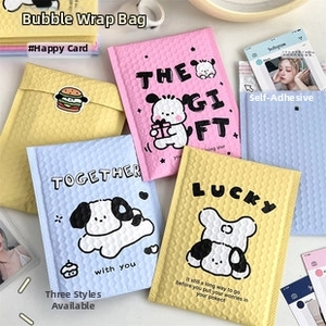 Detailed view of pink bubble mailers with cute dog prints and self-adhesive seal