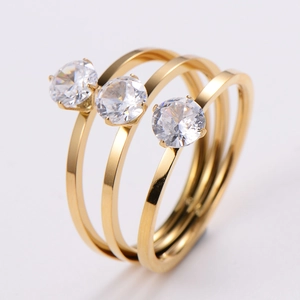 Macro shot of three-row gold plated ring with round brilliant cut cubic zirconia