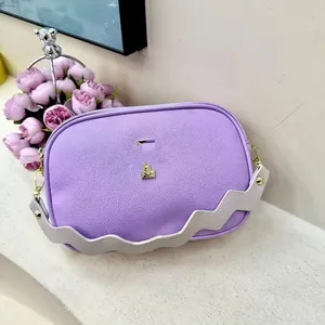 Purple lychee leather camera bag with wide wavy shoulder strap and golden buckle design