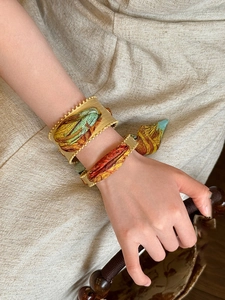 Detail of vintage matte gold open cuff bracelet with Van Gogh style silk scarf wrap