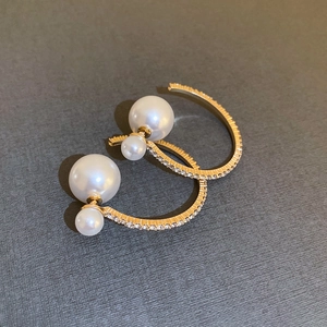Elegant C-shaped gold pearl earrings with sparkling crystals for a sophisticated look