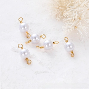 Detailed view of five 18K gold-plated pearl connectors for DIY jewelry making