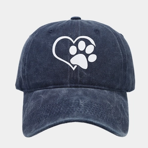 Detailed view of heart and paw print on navy blue washed cotton baseball cap