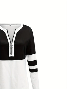 Close-up of a color-block striped sweatshirt with a V-neck and metal ring zipper detail