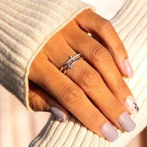 Macro detail of double layered s925 silver ring featuring sparkling zircon cross accents