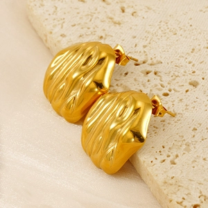 Macro shot of 18K gold plated stainless steel earrings with irregular wrinkled texture