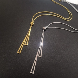 Detail of gold and silver triangle pendant necklaces with adjustable slider box chain