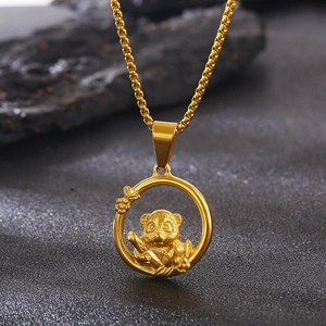 Macro shot of gold stainless steel panda pendant necklace with bamboo motif detail