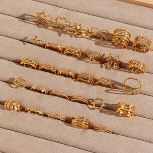 Set of 24 gold plated stainless steel rings featuring hollow hearts and woven designs