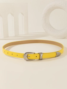 Detail of yellow thin leather belt with silver metal buckle on minimalist background