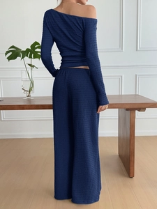 Navy blue textured two-piece set featuring off-shoulder top and wide-leg trousers back view