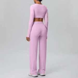 Rear view of pink long sleeve crop top and high waist wide leg yoga pants set