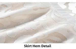Close-up of elegant white floral lace embroidery and mesh hem details of the dress