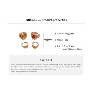 Detail view of retro alloy rings with amber resin hearts and precise dimensions