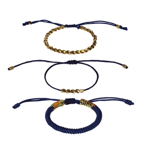 Set of three handmade navy blue woven bracelets with gold beads and colorful accents