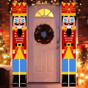 Pair of Nutcracker soldier Christmas door banners hanging on a white front door