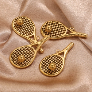 Golden stainless steel tennis racket pendants with mirror polish on silk background