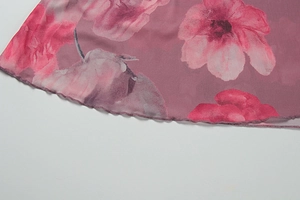 Macro detail of floral mesh fabric with lettuce edge hem on a vintage dress