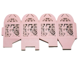 Detailed view of pink laser-cut wedding candy box with Mr & Mrs silhouette design