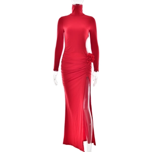 Detailed view of red high-neck maxi dress featuring side slit and waist flower ornament