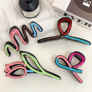 Elegant tulip and bow hair claws in pink, blue, and green on a soft white background