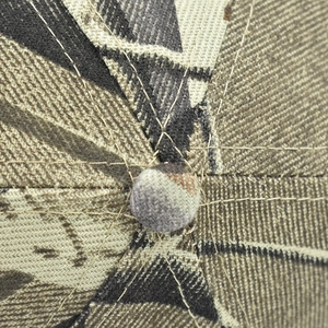 Macro view of 3D fish camouflage baseball cap top showing stitching and fabric texture