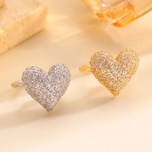 Macro detail of adjustable heart rings in gold and silver with zircon pavé setting
