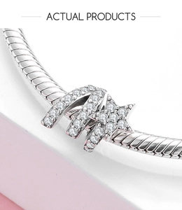 Macro shot of S925 silver charm with pave cubic zirconia on a snake chain bracelet