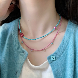 Double-layered turquoise and pink beaded necklace with natural stone and pearl accents