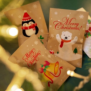 Christmas kraft paper gift bags with cute penguin and polar bear festive patterns