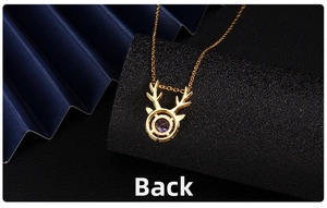 Detailed back view of golden elk antler pendant showing purple gemstone setting and chain
