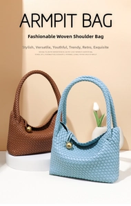 Close-up of woven tote bags featuring a gold sphere charm and intricate artisan leather texture