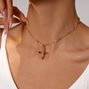 Cross necklace with multicolored crystals and gold beads on a delicate chain