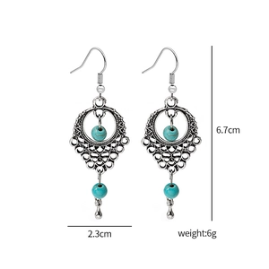 Detailed view of silver bohemian tassel earrings with blue beads and size measurements