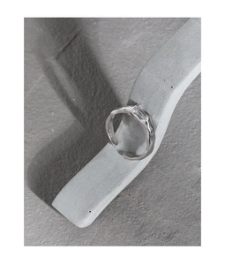 Detailed macro view of silver hammered texture ring with a square-cut zircon stone