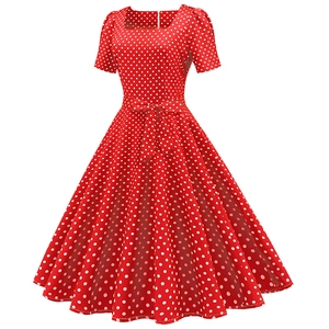 Detail view of red polka dot dress featuring a retro square neck and waist-tie bow