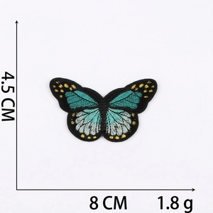 Detailed view of blue butterfly embroidered patch with dimensions 8cm by 4.5cm