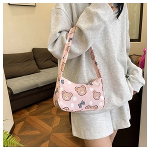 Detailed view of pink fabric shoulder bag with cute bear print and white polka dots