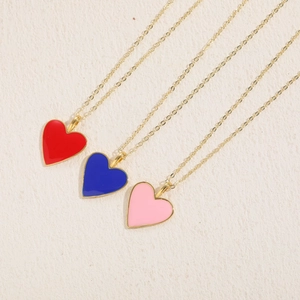 Three minimalist heart pendant necklaces in red, blue, and pink with 14K gold-plated chains