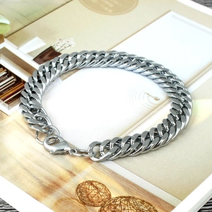 Polished silver titanium steel Cuban link bracelet for men and women on aesthetic background