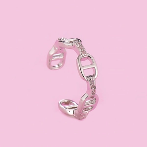 Macro detail of silver-toned anchor chain ring with cubic zirconia micro-inlays