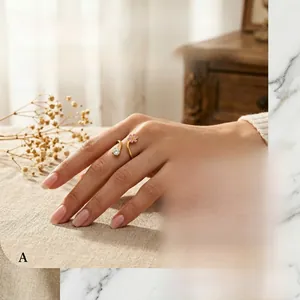 Detail of a spiral gold ring with pink enamel flower and sparkling zircon stone inlay