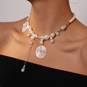 Elegant pearl and shell necklace with silver chain and fringe drops on a model