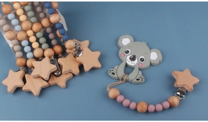 Detail of baby pacifier chain with silicone beads and a cute wooden koala teether charm