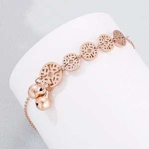 Rose gold stainless steel anklet with hollow coin links and double bell pendants