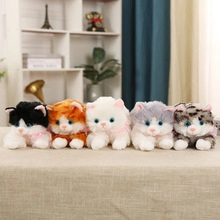 Detailed view of colorful plush cats with pink bows in various fur patterns and textures