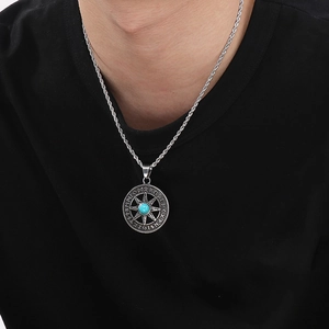 Close-up of Nordic Viking compass pendant with turquoise stone on twisted silver rope chain